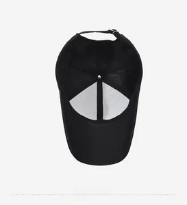 Interior detail of a classic black 6-panel baseball cap showing stitching and adjustable strap