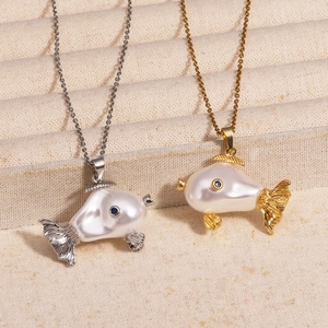 Close-up of cute fish necklaces featuring white pearl body and blue gemstone eye detail