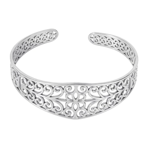 Detailed macro shot of a silver steel cuff bracelet with vintage filigree floral carving