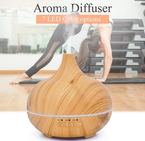 Detail of light wood grain aroma diffuser with 7 LED color options for yoga relaxation