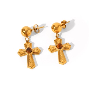 Detail view of gold cross drop earrings with tiger eye stone and textured surface