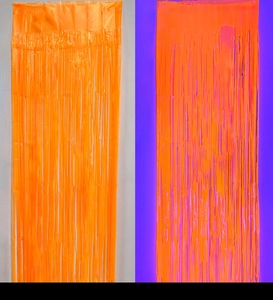 Neon orange fluorescent fringe curtain backdrop for parties shown in UV and natural light