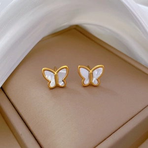 Minimalist titanium steel butterfly studs with white shell inlay on satin background