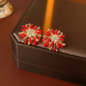 Macro shot of red enamel firework stud earrings with gold plating and crystals