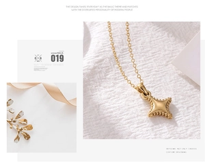 Detail of a minimalist gold star pendant on white fabric with elegant lighting effects