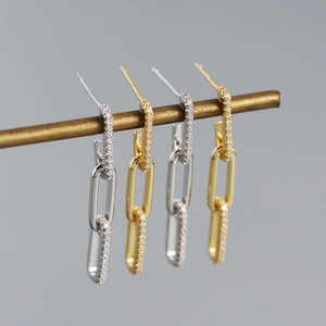 Detailed view of S925 silver link earrings with pave zircon on vintage brass display stand