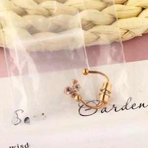 Detail of gold ear stud with three triangle crystals and screw back in packaging