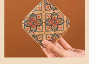 Macro view of portable square cork jewelry case with vintage floral tile patterns