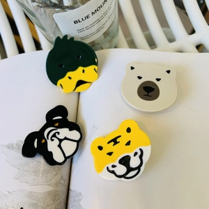 Set of four cute cartoon animal hair clips including tiger and duck on an open book