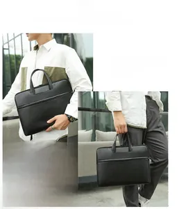 Close-up of black pebble leather laptop bag featuring dual handles and premium texture