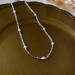 Silver square bead necklace with pearls and heart fringe in a vintage aesthetic