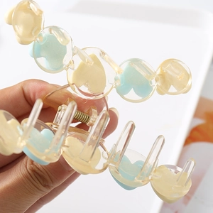 Matte heart-shaped hair claw clip in cream and blue tones for women's hairstyles