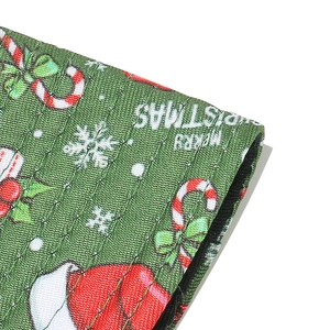 Macro detail of Christmas bucket hat fabric featuring festive patterns and knit texture