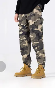 Detail of men's woodland camo cargo pants showing large side pockets and drawstring waist
