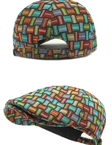Detail of colorful woven plaid fabric texture and adjustable bronze buckle on the flat cap