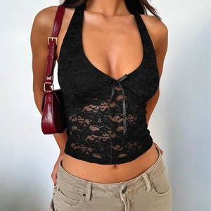 Close-up of black lace halter top showing intricate mesh patterns and bow tie details