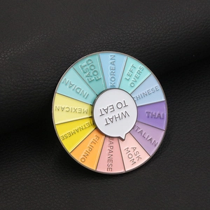 Macro shot of colorful enamel decision wheel brooch with What To Eat food options text