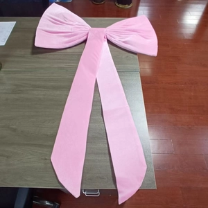 Detail of a large pale pink velvet decorative bow for wedding and party backdrops