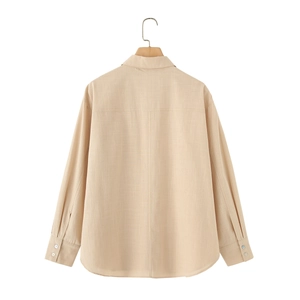 Detail view of the beige linen shirt back showing breathable fabric texture and stitching