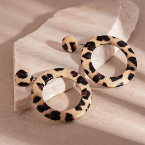 Exaggerated leopard print faux leather hoop earrings with minimalist geometric design