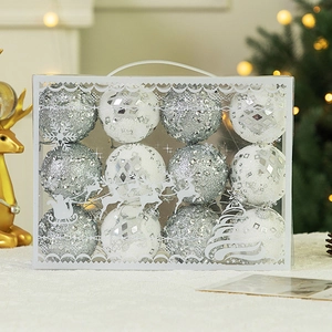 Close-up of 12 glittery silver and white Christmas foam balls in transparent gift box