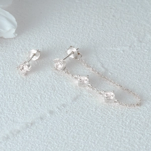 Macro view of S925 sterling silver stud with hallmark and delicate zircon chain
