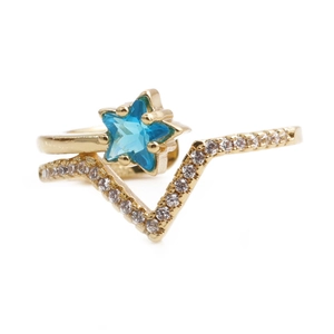 Detailed shot of golden V-shaped ring featuring a central blue star gemstone and white crystals