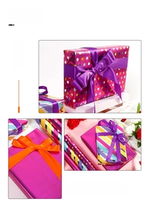 Close-up of colorful striped, polka dot, and metallic pink gift wrapping paper rolls