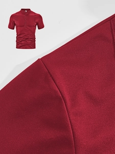 Detailed close-up of red polo shirt fabric texture with high-quality stitching and collar