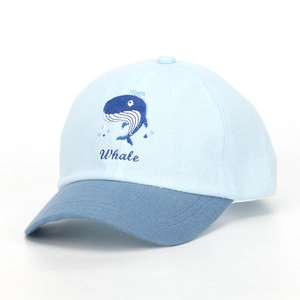 Detail of blue patchwork baseball cap featuring high-quality whale embroidery for kids