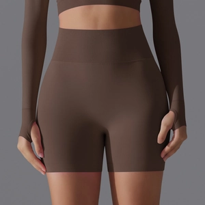 Detail of high-waist seamless yoga shorts with wide ribbed waistband and thumbhole sleeves