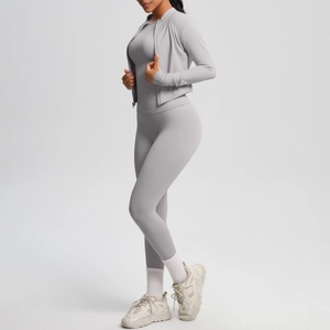 Detail view of a slim-fit light gray 3-piece yoga set with zip-up jacket and high-waist leggings