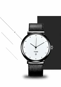 Close-up of minimalist watch with white dial, calendar display, and black leather strap
