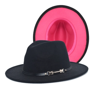 Detail showing black fedora hat with pink interior and decorative leather strap with buckle