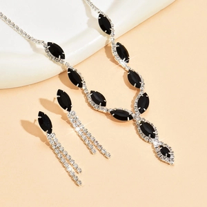 Detail of V-shaped necklace and tassel earrings set with marquise black stones and diamonds