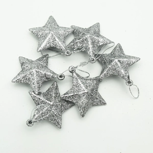 Macro detail of six glittery silver star ornaments for sparkling Christmas tree decoration