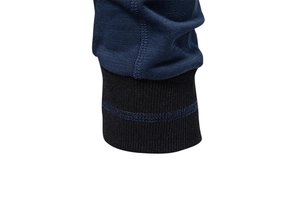 Macro shot of navy blue baseball jacket cuffs with black ribbing and double stitching detail