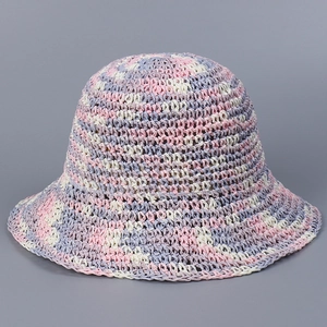 Close-up of handmade crochet sun hat with pink, purple, and beige woven texture