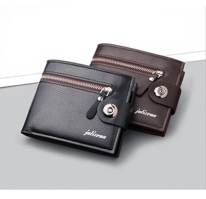 Detail of lychee pattern leather wallet with zip pocket and magnetic buckle closure