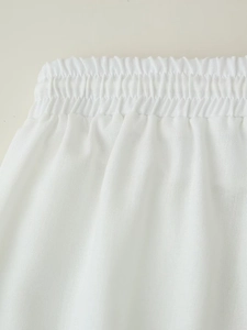 Detailed macro view of the elastic waistband on white cotton linen blend lounge pants