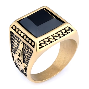 Macro detail of golden Masonic signet ring with black gemstone and square symbol