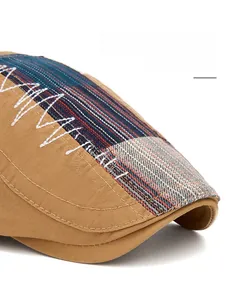 Detail of wide foldable brim and ethnic striped stitching on canvas newsboy hat