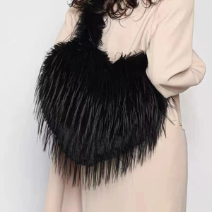 Fashionable black faux fur heart crossbody bag with long plush fringe for women