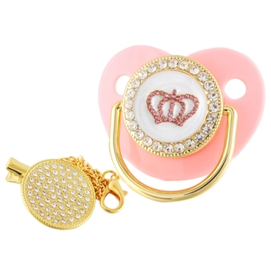 Detail of luxury crown heart baby pacifier with gold clip and pink rhinestones
