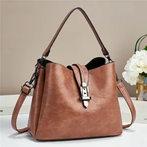 Retro brown leather bucket bag for women with top handle and adjustable shoulder strap