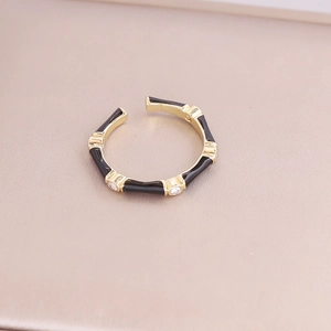 Detail of bamboo joint ring with black enamel, sparkling zircon and gold metal finish
