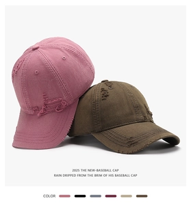 Detailed view of distressed ripped texture and vintage washed cotton on a baseball cap