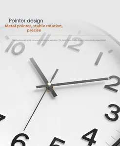 Macro detail of minimalist metal clock pointers and dial of a modern quartz wall clock