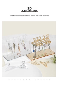 Detailed view of mini hanger shaped acrylic earring stand in clear and amber colors