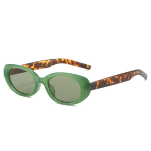 Vintage oval sunglasses with translucent green frames and tortoiseshell temples for style